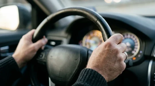 Close-up view of an electric vehicle driver monitoring real-time efficiency metrics during efficient driving