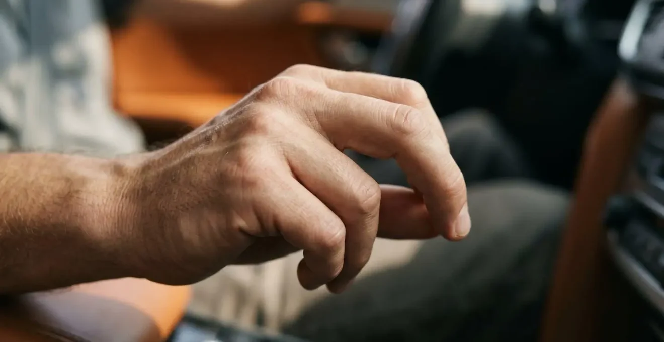 Symbolic close-up of a hand making a precise adjustment gesture suggesting skilled vehicle control