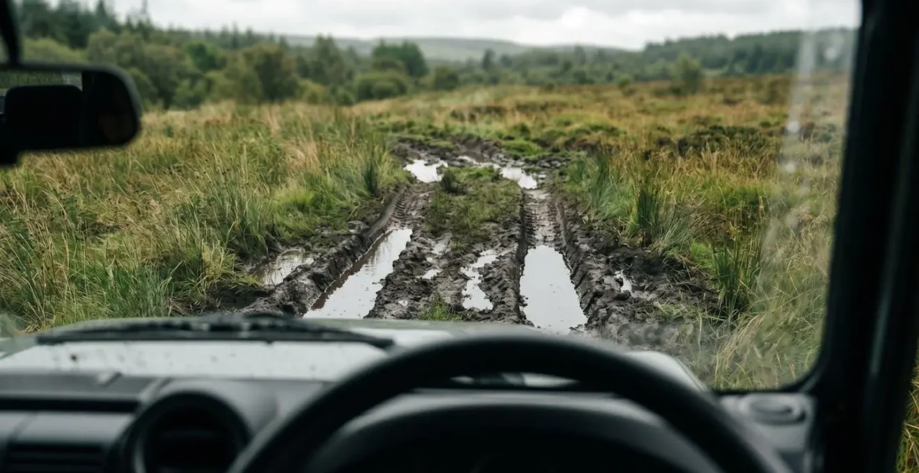 Close-up of challenging off-road terrain showing deep muddy ruts and deceptive surface conditions